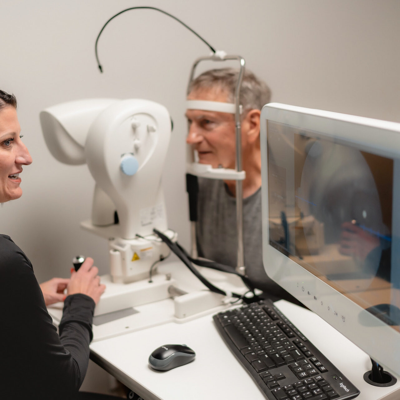 Dr. Becky runs an eye exam on older man