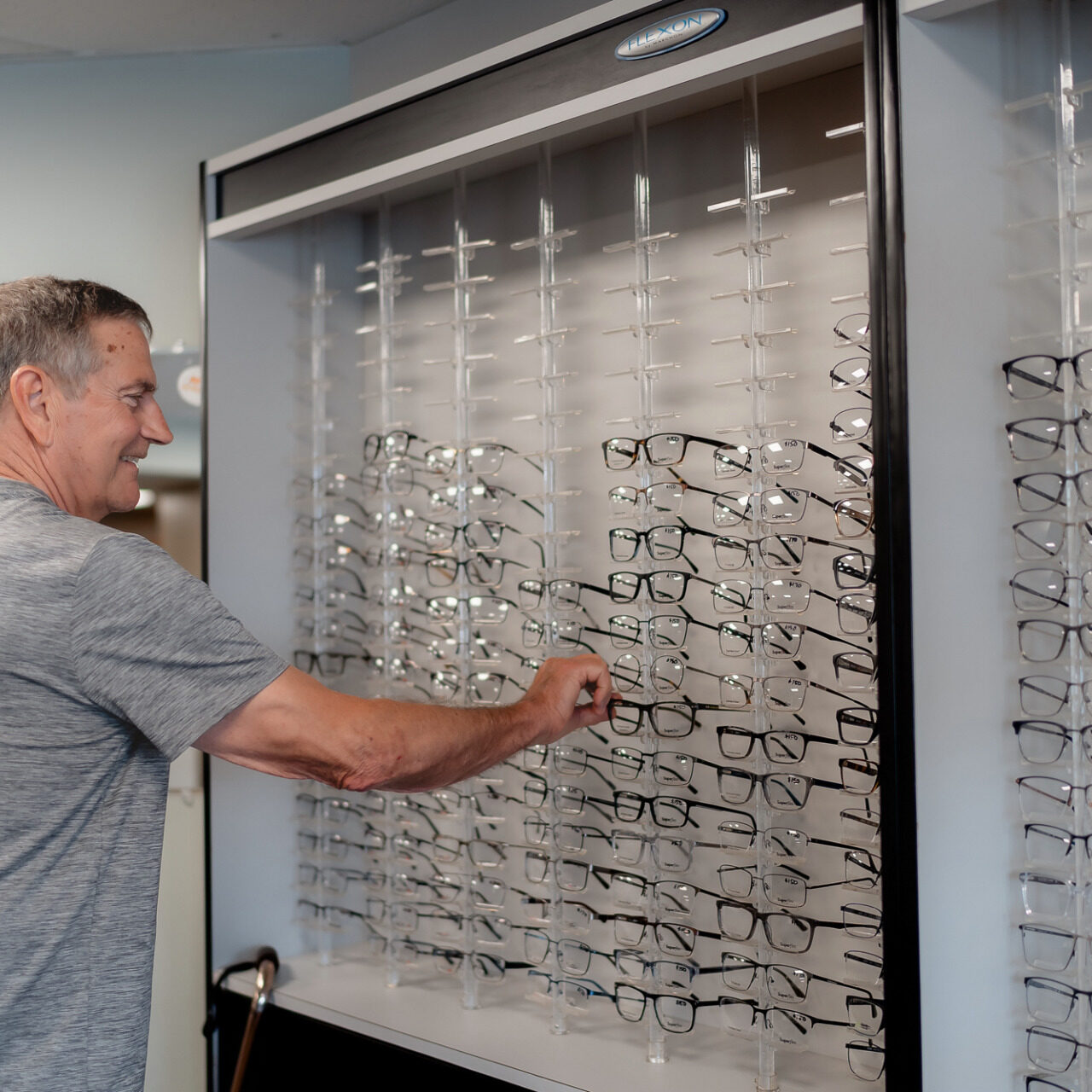 Man searches display for a pair of glasses