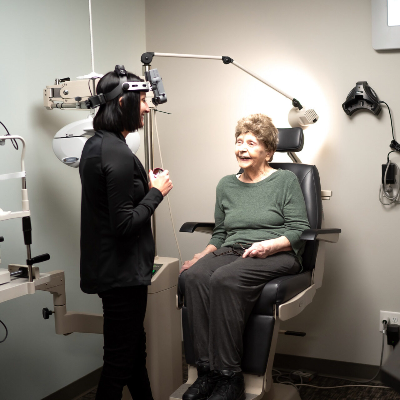 Dr. Becky runs a routine eye exam on older woman